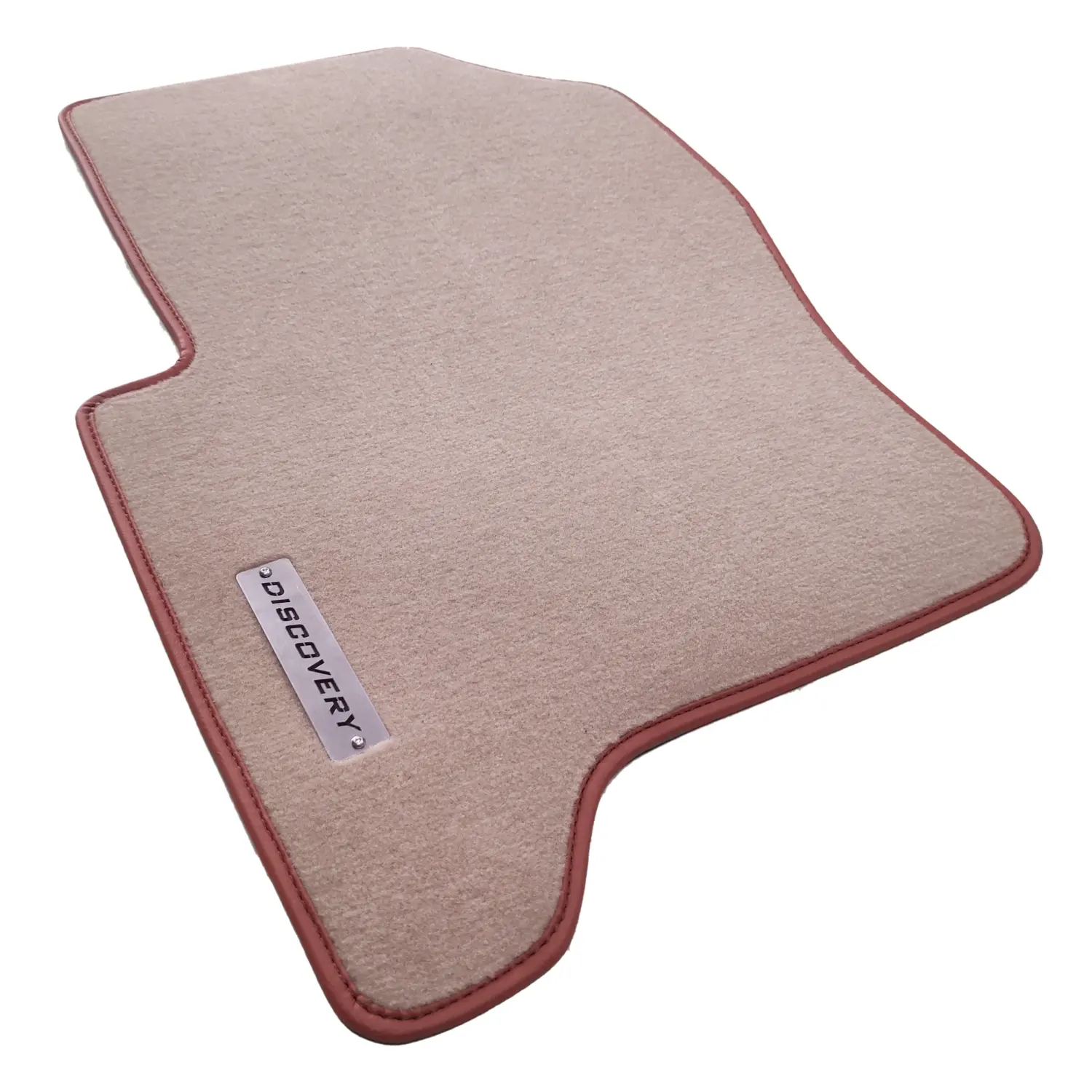 Land Rover Discovery serisi bej halı paspas, taba rengi deri biye ve metal Discovery logolu.